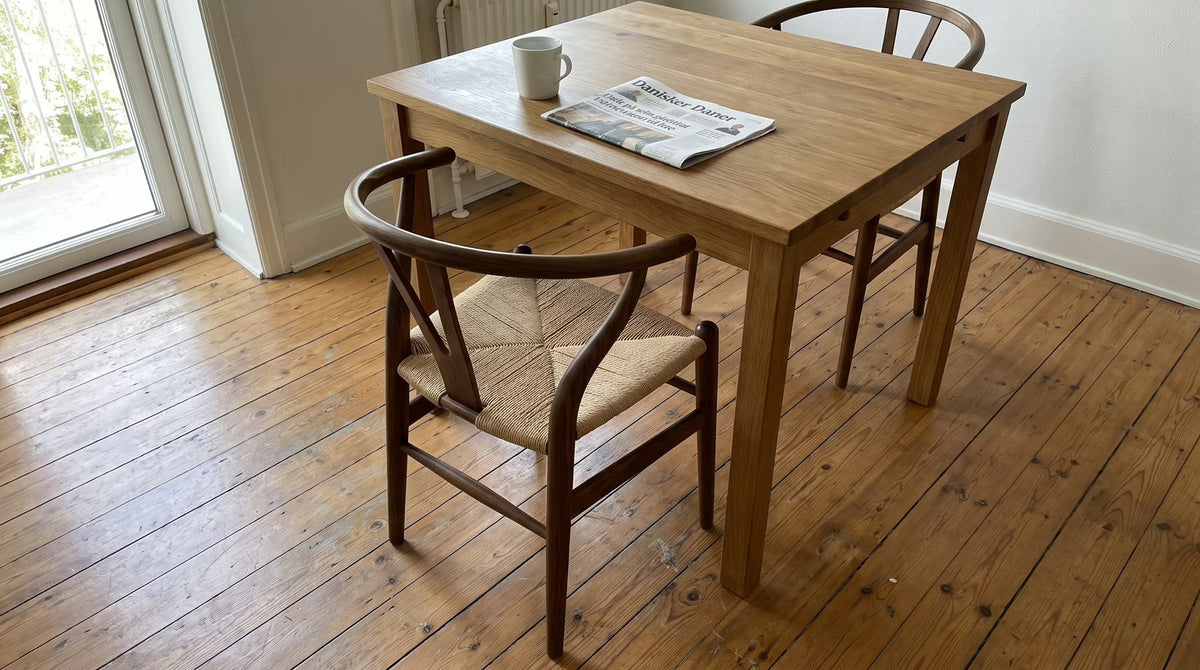 Curved wooden dining chairs with woven seats around a table