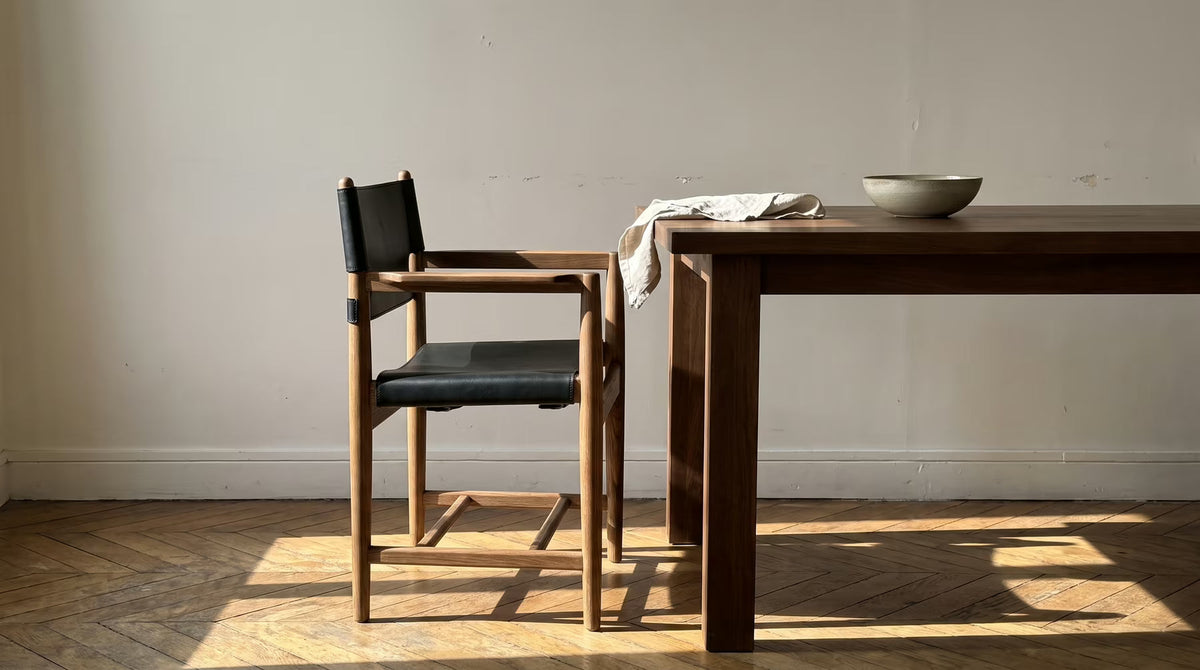 Walnut-toned dining armchair beside a wooden table