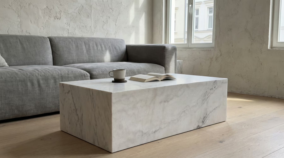 White marble coffee table beside a gray sofa in a modern room