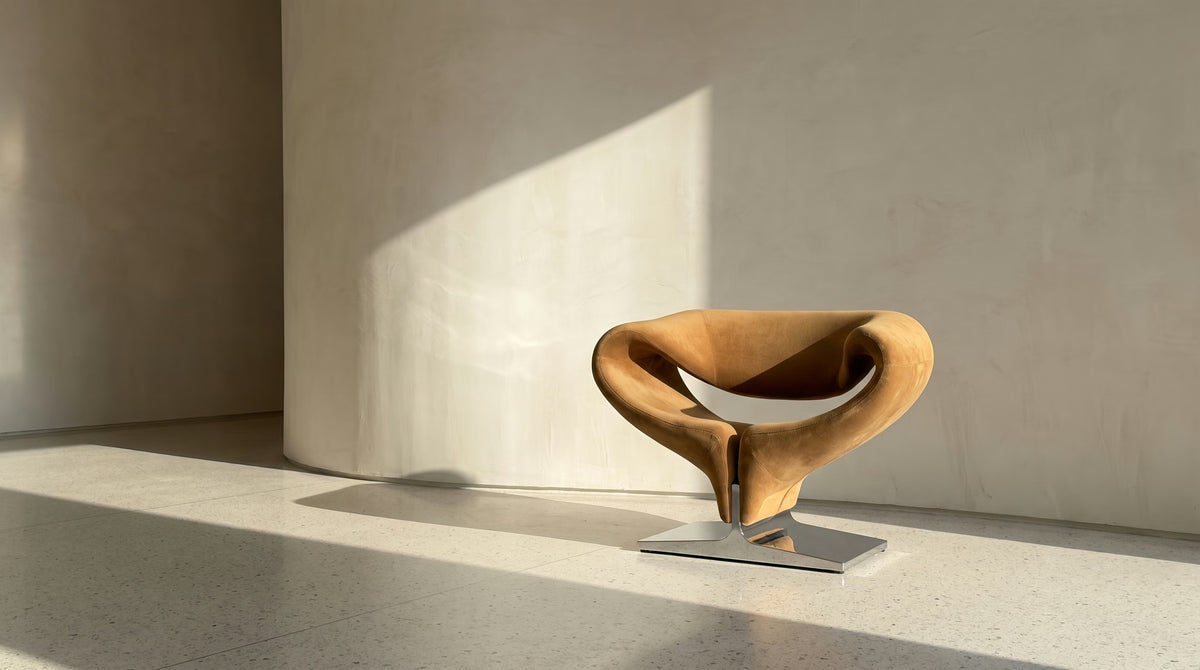 Riban 66 Chair in plush velvet by Madorne against a curved plaster wall